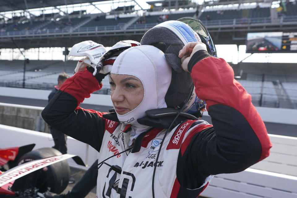 Katherine Legge, of England, takes off her helmet after she qualified for the Indianapolis 500 auto race at Indianapolis Motor Speedway, Saturday, May 20, 2023, in Indianapolis. (AP Photo/Darron Cummings)