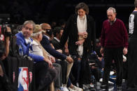 Businessman Michael Bloomberg, right,, and Diana Taylor return to their seats during a time out in the second half of an NBA basketball game between the Brooklyn Nets and the New York Knicks, Tuesday, Nov. 30, 2021, in New York. The Nets won 112-110. (AP Photo/Mary Altaffer)