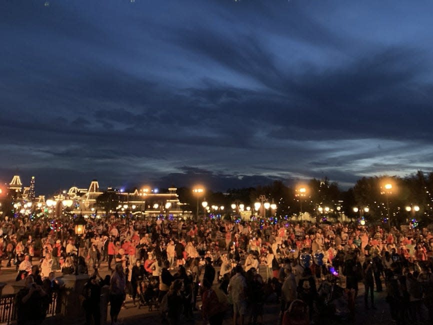 Magic Kingdom guests emerging from Main Street USA at a point that connects all of the various _lands_ of the park