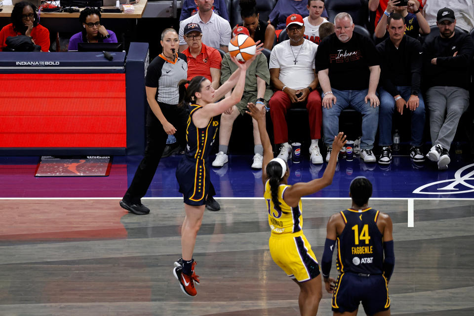 INDIANAPOLIS, IN - MAY 28: Indiana Fever guard Caitlin Clark (22) takes a 3 point shot against Los Angeles Sparks guard Aari McDonald (15) on May 28, 2024, at the Gainbridge Fieldhouse in Indianapolis, Indiana. (Photo by Brian Spurlock/Icon Sportswire via Getty Images)