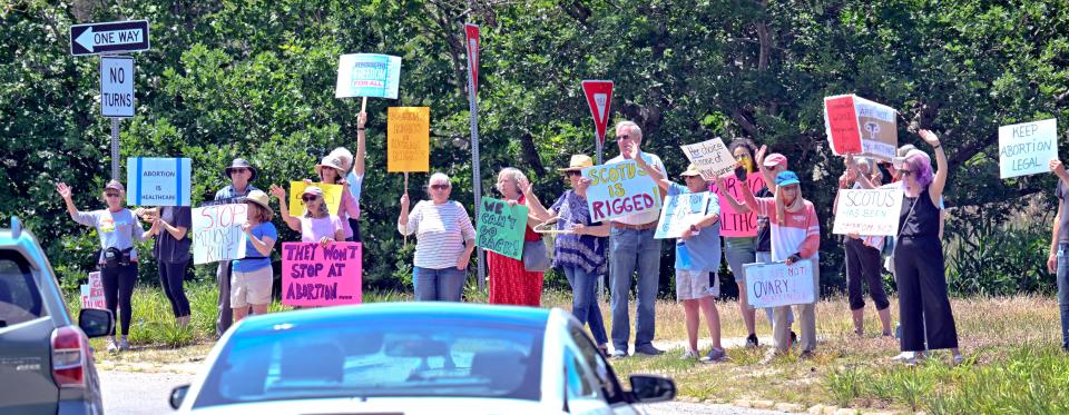Abortion rights supporters gathered on Friday at the Orleans Rotary, organized by Indivisible Outer Cape, to protest the Supreme Court ruling released earlier in the day that the Constitution provided no right to abortion.