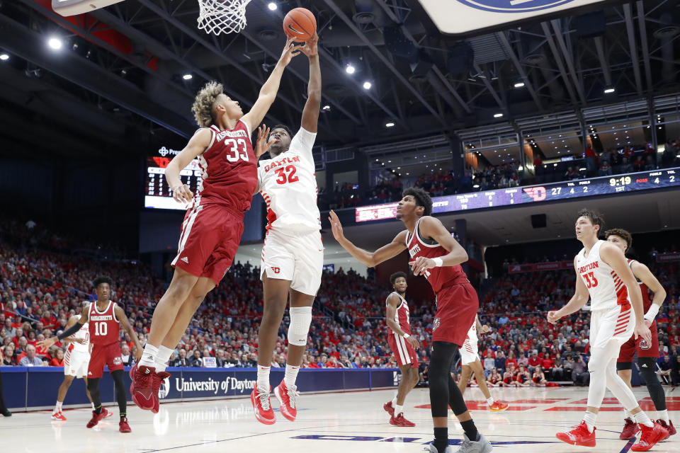 Dayton's Jordy Tshimanga (32) shoots against Massachusetts' Tre Mitchell (33) during the first half of an NCAA college basketball game, Saturday, Jan. 11, 2020, in Dayton. (AP Photo/John Minchillo)