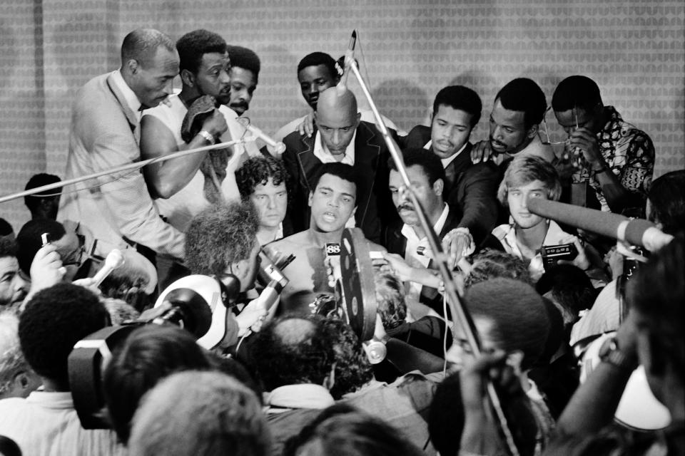 Muhammad Ali, shown in 1974 speaking to reporters prior to his fight in Africa with George Foreman, is the subject of a documentary produced by LeBron James that will debut on HBO on May 14. (Getty Images)