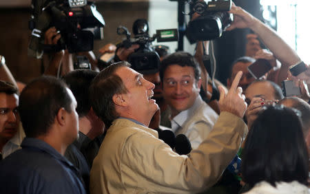 Presidential candidate Jair Bolsonaro greets supporters as he talks to media after a visit to Federal Police headquarters in Rio de Janeiro, Brazil October 17, 2018. REUTERS/Ricardo Moraes