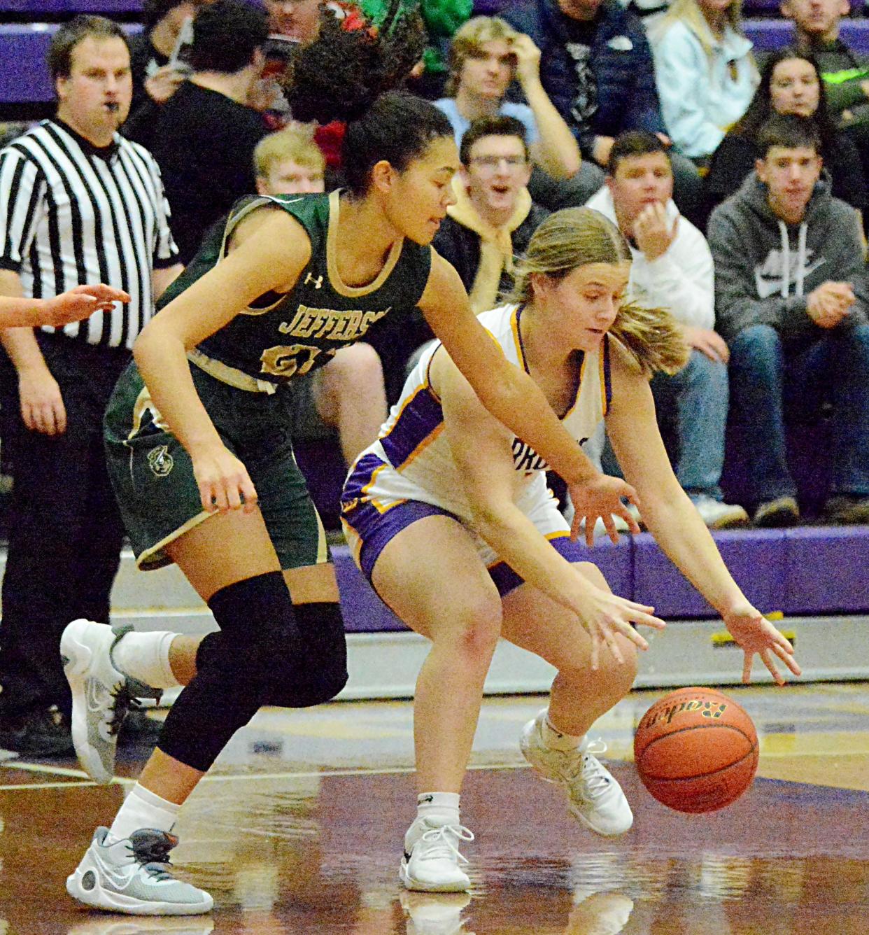 Watertown's Jade Lund (right) grabs a loose ball against Sioux Falls Jefferson's Jaidyn Dunn during their high school girls basketball game on Tuesday, Feb. 7, 2023 in the Watertown Civic Arena. No. 1 Jefferson won 49-40 in overtime.