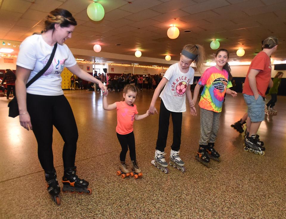Taken in 2016 at Dixie Skateland, Amy Miller of Temperance holds the hand of her daughter Hilary, then 3, as she skates for the first time, with friends Lexi Ripple, then 9, and Madison Peek, then 11.