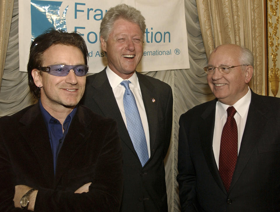 FILE Former U.S. President Clinton, center, shares a laugh with Former Soviet President Mikhail Gorbachev, right, and Bono, left, of the rock group U2, before a dinner hosted by Mr. Gorbachev, at the Russian Embassy in New York in honor of the Frank Foundation Child Assistance International of Washington D.C. on Sunday, March 10, 2002. Russian news agencies are reporting that former Soviet President Mikhail Gorbachev has died at 91. The Tass, RIA Novosti and Interfax news agencies cited the Central Clinical Hospital. (AP Photo/Stephen Chernin, Pool, File)