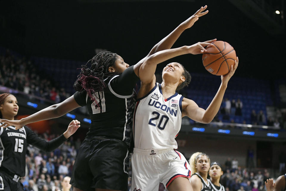 Connecticut's Olivia Nelson-Ododa (20) shoots as Georgetown's Ariel Jenkins (21) defends in the first half of an NCAA college basketball game in the quarterfinals of the Big East Conference tournament at Mohegan Sun Arena, Saturday, March 5, 2022, in Uncasville, Conn. (AP Photo/Jessica Hill)