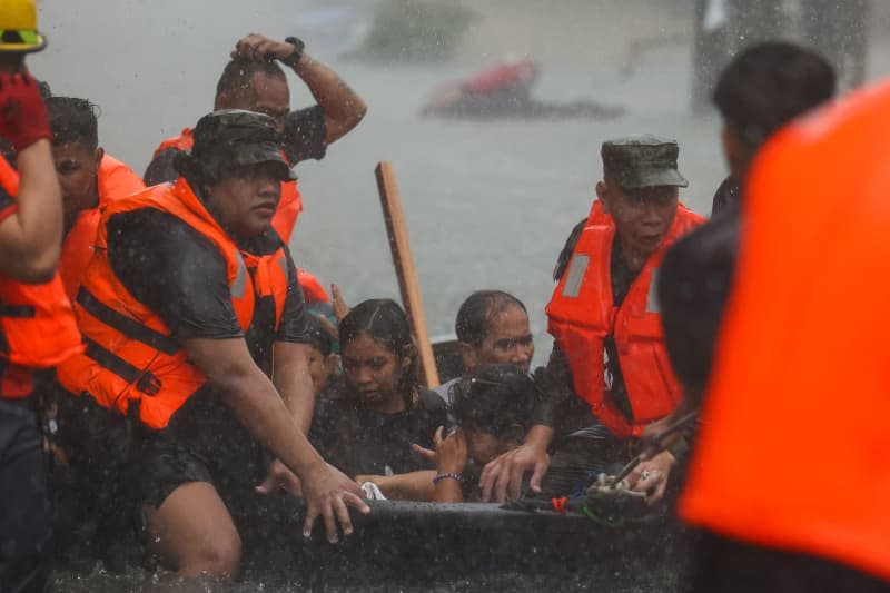 Disaster relief workers use a small boat to rescue residents trapped in their flooded homes after heavy monsoon rains in Manila. The Philippine government has declared a state of emergency in Manila after heavy rains caused by the southwest monsoon and Typhoon Gaemi caused significant flooding in the city and surrounding areas. Basilio Sepe/ZUMA Press Wire/dpa