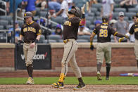 San Diego Padres' Fernando Tatis Jr., center, reacts as he crosses home plate after hitting a grand slam during the seventh inning of a baseball game against the New York Mets at Citi Field, Sunday, June 13, 2021, in New York. (AP Photo/Seth Wenig)