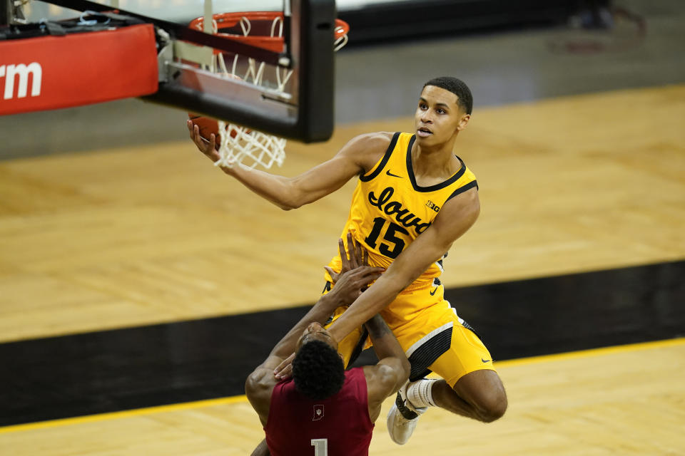 Iowa forward Keegan Murray (15) drives to the basket over Indiana guard Al Durham (1) during the second half of an NCAA college basketball game, Thursday, Jan. 21, 2021, in Iowa City, Iowa. Indiana won 81-69. (AP Photo/Charlie Neibergall)