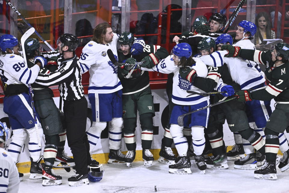 Toronto and Minnesota players skirmish during the second period of the NHL Global Series Sweden ice hockey match between Toronto Maple Leafs and Minnesota Wild at Avicii Arena in Stockholm, Sweden, Sunday, Nov. 19, 2023. (Claudio Bresciani/TT via AP)