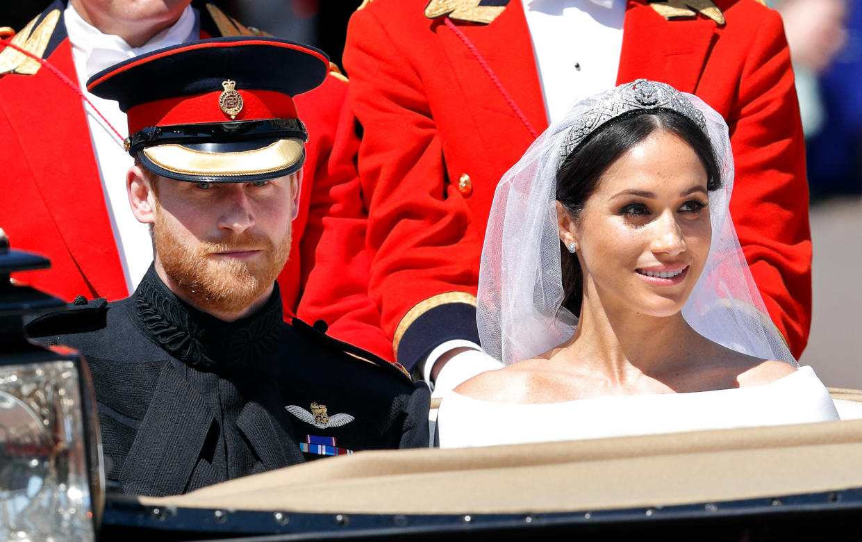 WINDSOR, UNITED KINGDOM - MAY 19: (EMBARGOED FOR PUBLICATION IN UK NEWSPAPERS UNTIL 24 HOURS AFTER CREATE DATE AND TIME) Prince Harry, Duke of Sussex and Meghan, Duchess of Sussex travel in an Ascot Landau carriage as they begin their procession through Windsor following their wedding at St George's Chapel, Windsor Castle on May 19, 2018 in Windsor, England. Prince Henry Charles Albert David of Wales marries Ms. Meghan Markle in a service at St George's Chapel inside the grounds of Windsor Castle. Among the guests were 2200 members of the public, the royal family and Ms. Markle's Mother Doria Ragland. (Photo by Max Mumby/Indigo/Getty Images)