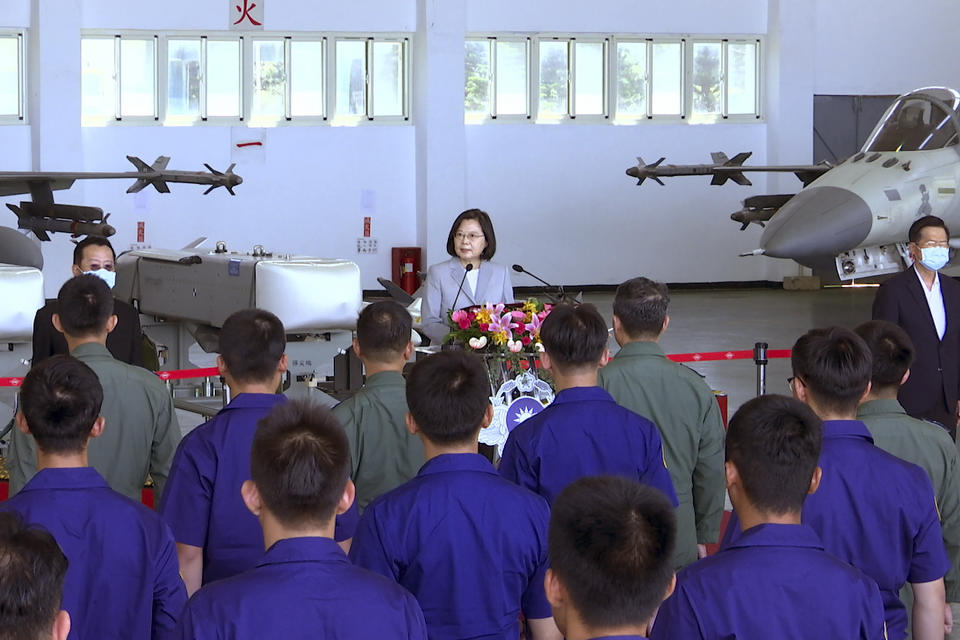 Taiwan President Tsai Ing-wen, center, speaks near Taiwan's Indigenous Defense Fighter (IDF) jets displayed during a visit to the Penghu Magong military air base in outlying Penghu Island, Taiwan Tuesday, Sept. 22, 2020. Tsai visited the military base on one of Taiwan’s outlying islands Tuesday in a display of resolve following a recent show of force by rival China. (AP Photo/Johnson Lai)