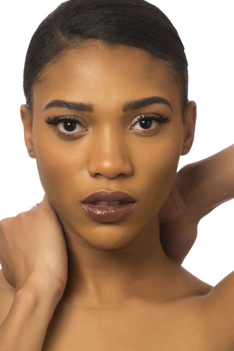 A model poses wearing one of the nude lipsticks from Mented Cosmetics.