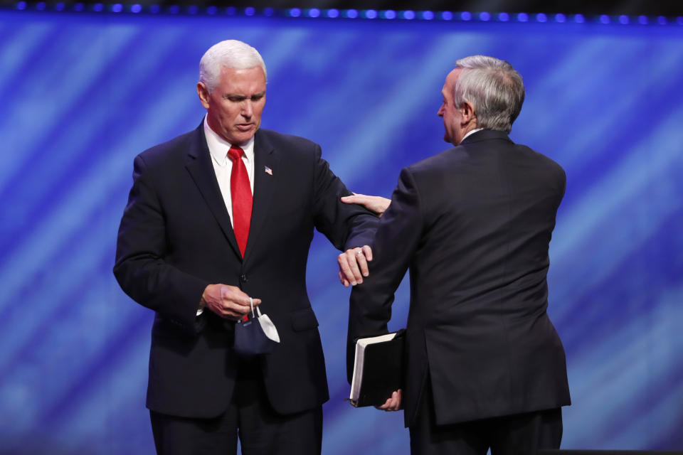 Vice President Mike Pence, left, greets Senior Pastor Dr. Robert Jeffress, right, after Pence spoke at the Southern Baptist megachurch First Baptist Dallas during a Celebrate Freedom Rally in Dallas, Sunday, June 28, 2020. (AP Photo/Tony Gutierrez)