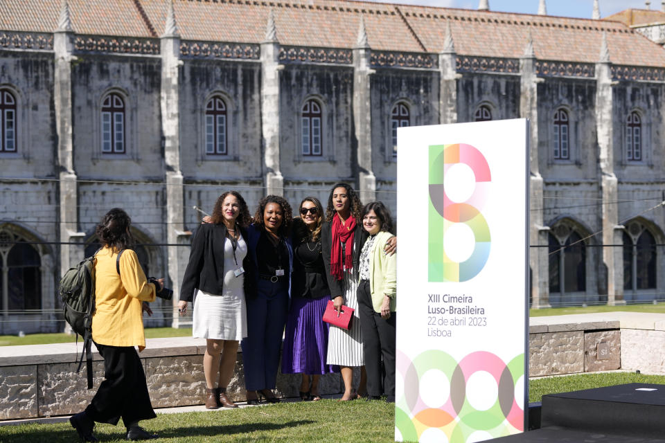 Brazilian government ministers pose for an informal group photo with the 16th century Jeronimos monastery in the background, during the Portugal-Brazil summit at the Belem Cultural Center in Lisbon, Saturday, April 22, 2023. They are, from right, Health Minister Nisia Trindade, Minister of Racial Equality Anielle Franco, Brazilian first lady Rosangela da Silva, Culture Minister Margareth Menezes and Science and Technology Minister Luciana Santos. (AP Photo/Armando Franca)