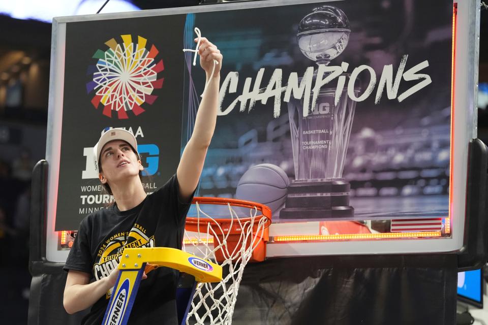 Caitlin Clark, the biggest name in women's college basketball, cuts down the net after Iowa's overtime win over Nebraska in the Big Ten Tournament title game March 10. The Hwkeyes are ranked second in the country.