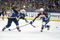 St. Louis Blues' Robert Thomas (18) shoots past Colorado Avalanche's Bowen Byram (4) during the second period in Game 3 of an NHL hockey Stanley Cup second-round playoff series Saturday, May 21, 2022, in St. Louis. (AP Photo/Jeff Roberson)