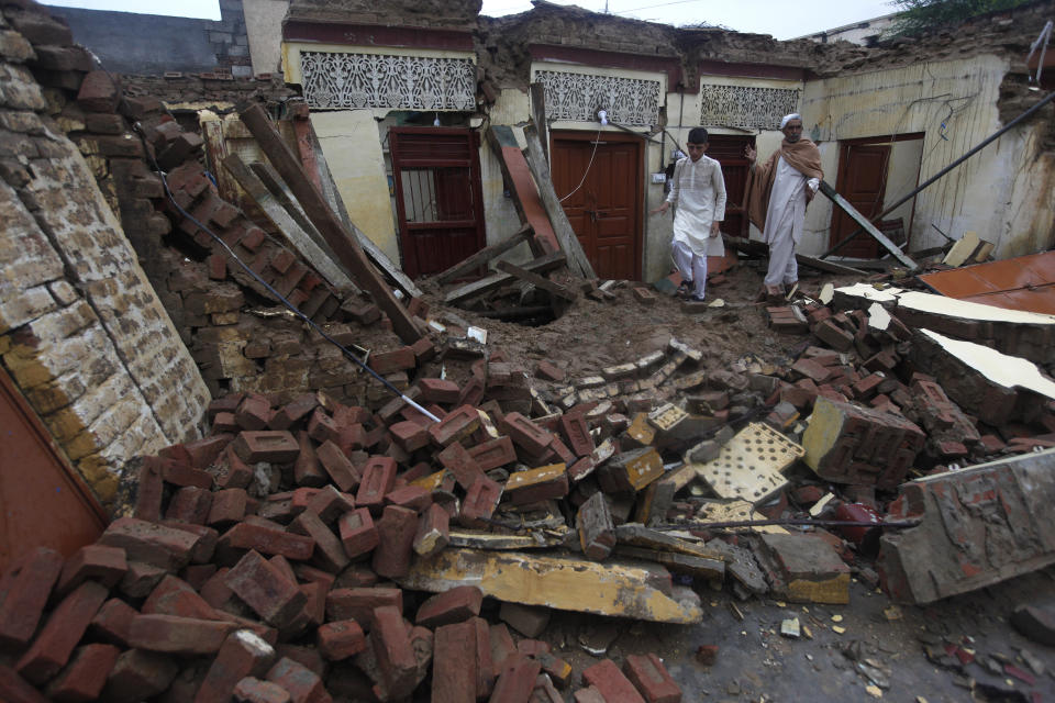 Men examine their damage house caused by a powerful earthquake struck in Sahang Kikri village near Mirpur, in northeast Pakistan, Wednesday, Sept. 25, 2019. A powerful earthquake struck northeast Pakistan Tuesday, badly damaging scores of home and shops and killing some people and injured over 700, officials, said. (AP Photo/Anjum Naveed)