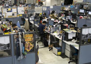 Reporters work at the news room of Apple Daily Monday, April 26, 2021 in Hong Kong. A newspaper that has advocated for greater democracy in Hong Kong came under further pressure Thursday, June 17, 2021, with the arrests of three top editors and two senior executives. (AP Photo/Vincent Yu)