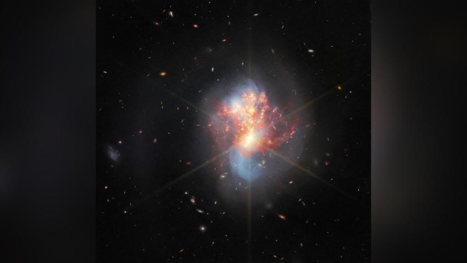 two white galaxies join into one in space