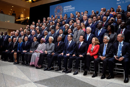 Central bank governors and other global finance officials sit for a group photo at the IMF and World Bank's 2019 Annual Spring Meetings, in Washington, April 13, 2019. REUTERS/James Lawler Duggan