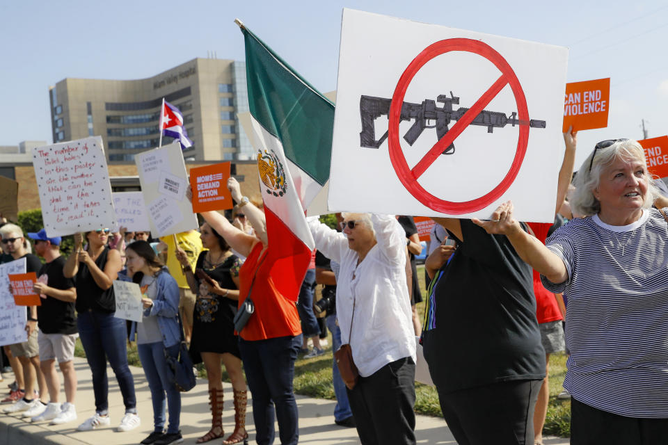 FILE - In this Aug. 7, 2019, file photo, demonstrators gather to protest after a mass shooting that occurred in Dayton, Ohio. The latest mass shootings in the United States have triggered multiple countries to warn their citizens to be wary of travel conditions there. (AP Photo/John Minchillo, File)