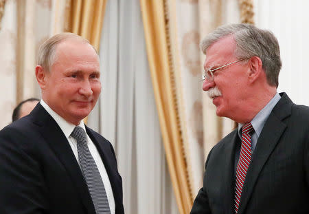 FILE PHOTO: Russian President Vladimir Putin (L) greets U.S. national security adviser John Bolton during a meeting at the Kremlin in Moscow, Russia Oct. 23, 2018. REUTERS/Maxim Shemetov/File Photo