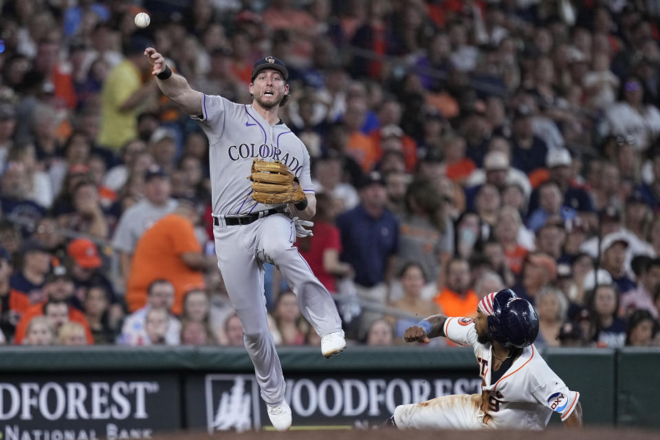 Colorado Rockies third baseman Ryan McMahon commits a throwing error on a ground ball from Houston Astros' Jose Abreu, after forcing out Corey Julks during the seventh inning of a baseball game Tuesday, July 4, 2023, in Houston. (AP Photo/Kevin M. Cox)