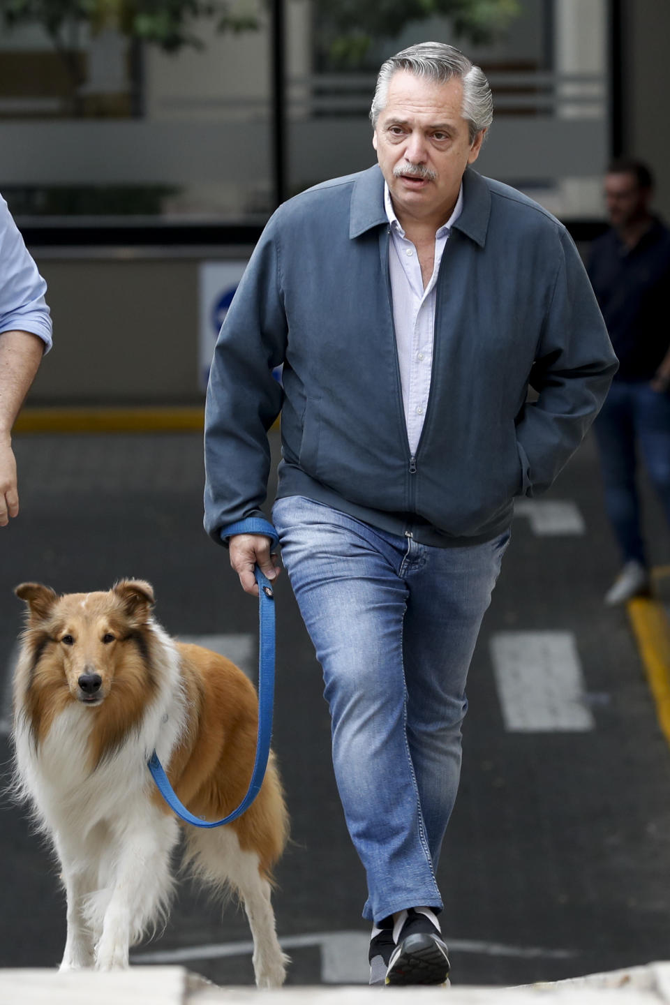 Presidential candidate Alberto Fernandez leaves his home to walk his dog prior to go to vote in presidential elections in Buenos Aires, Argentina, Sunday, Oct. 27, 2019. (AP Photo/Natacha Pisarenko)