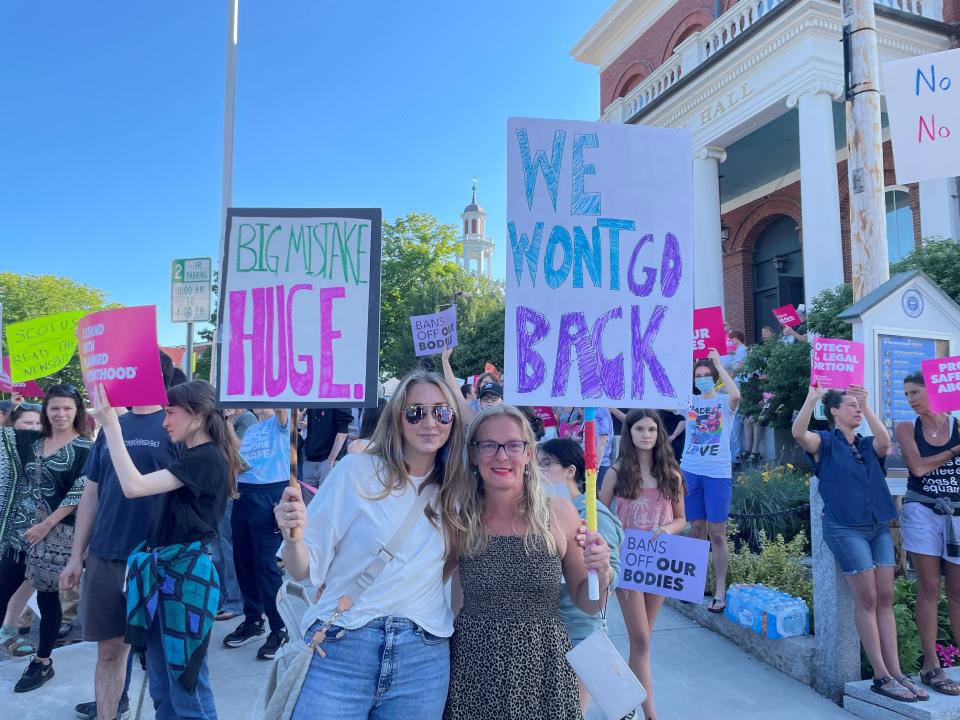 Sarah Elliott, left, and Jodie Bray Strickland protest the U.S. Supreme Court decision to overturn Roe v. Wade during a "Bans Off Our Bodies" rally at Exeter Town Hall on Friday, June, 24, 2022.