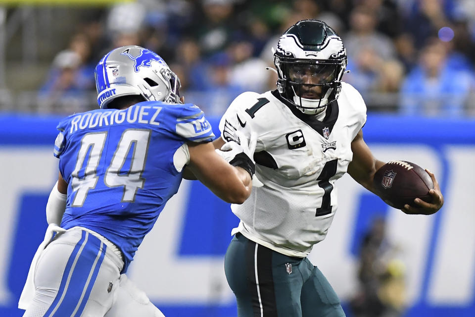 Philadelphia Eagles quarterback Jalen Hurts (1) runs the ball as Detroit Lions linebacker Malcolm Rodriguez (44) defends in the first half of an NFL football game in Detroit, Sunday, Sept. 11, 2022. (AP Photo/Lon Horwedel)