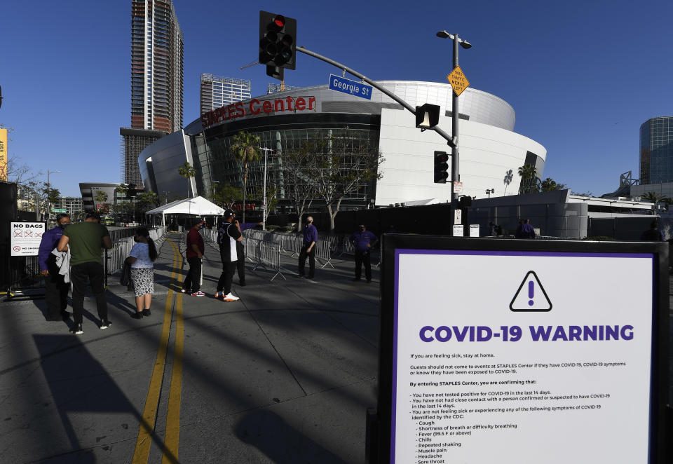 Ushers check vaccination cards at the Staples Center.