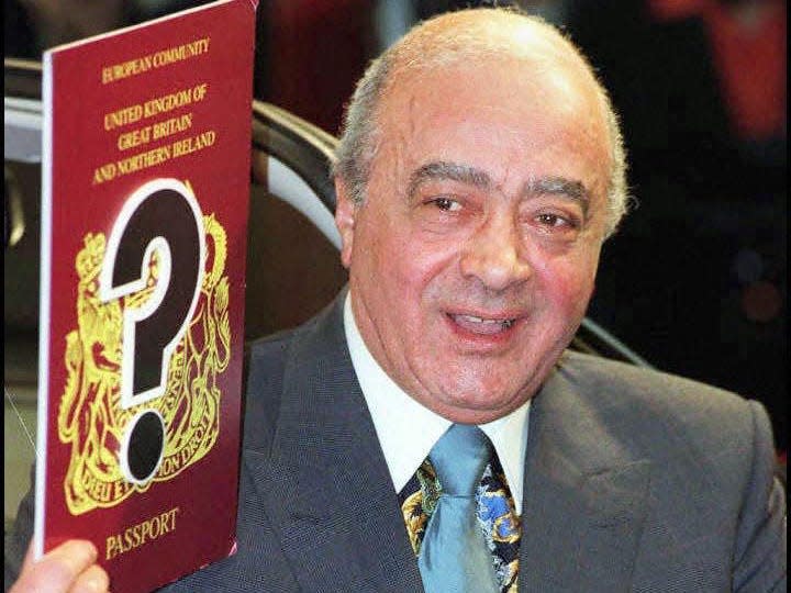 Mohamed Al Fayed holds up a mock passport following the decision by the Court of Appeal to overturn a High Court ruling to turn down their application for naturalisation because they had not been given the reasons for their refusal in1 1996.