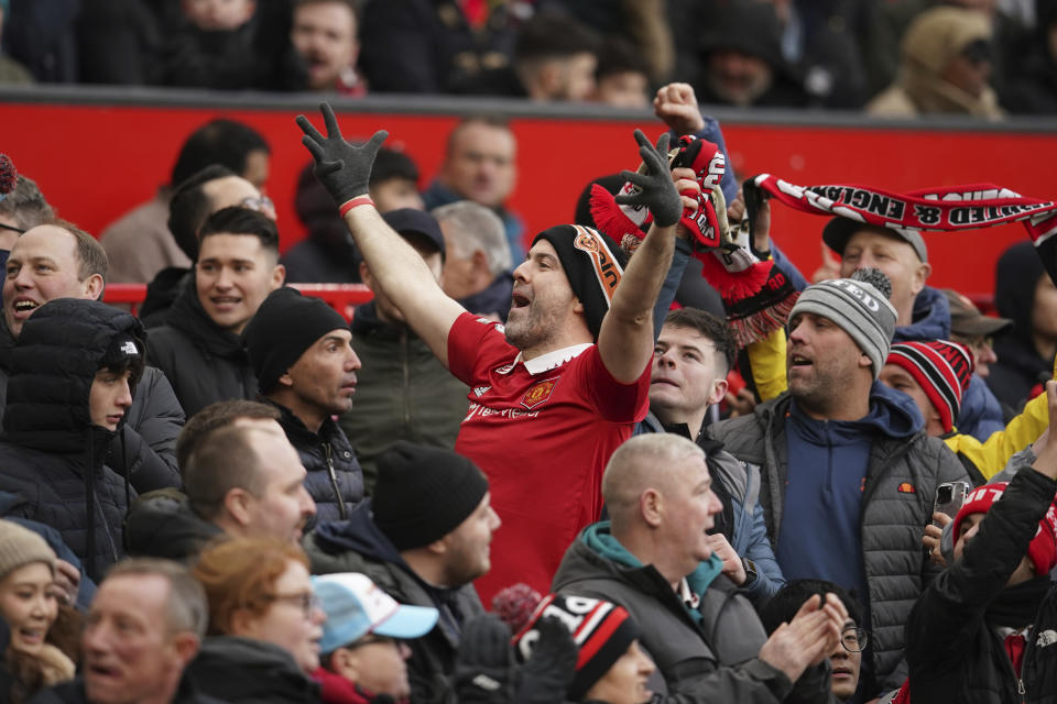 A fan cheers after Manchester United took the lead during the English Premier League soccer match between Manchester United and Manchester City at Old Trafford in Manchester, England, Saturday, Jan. 14, 2023. (AP Photo/Dave Thompson)
