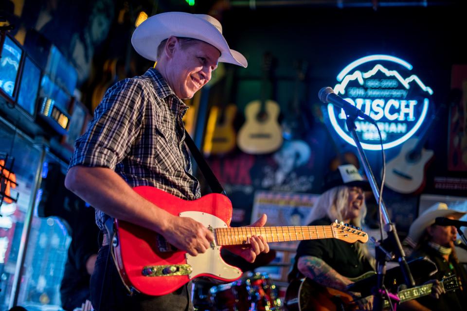 Musician John England plays guitar while performing with Sarah Gayle Meech at Robert's Western World in Nashville, Tenn., Thursday, Sept. 3, 2020.
