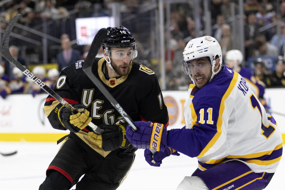 Vegas Golden Knights center Nicolas Roy (10) and Los Angeles Kings center Anze Kopitar (11) look for the puck during the second period of an NHL hockey game Saturday, Jan. 7, 2023, in Las Vegas. (AP Photo/Ellen Schmidt)