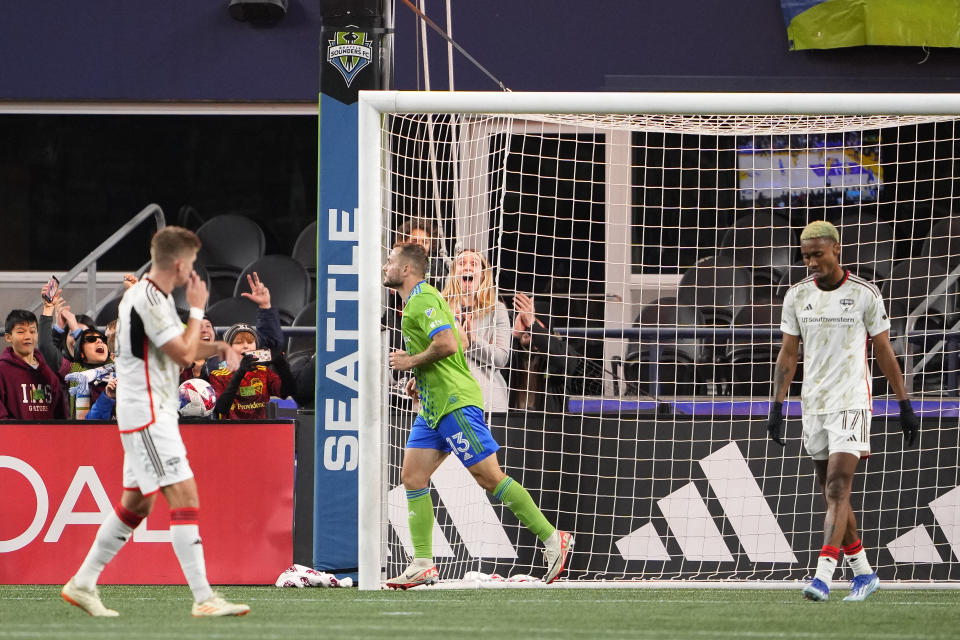 Seattle Sounders forward Jordan Morris (13) jogs away after scoring as FC Dallas defender Nkosi Tafari (17) looks down during the second half of an MLS playoff soccer match Monday, Oct. 30, 2023, in Seattle. (AP Photo/Lindsey Wasson)