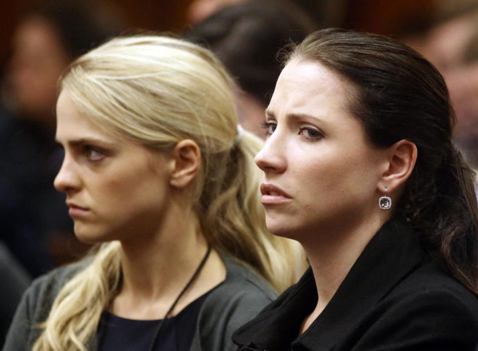 Sister of Oscar Pistorius, Aimee, right, listens to cross questioning in court during his trial at the high court in Pretoria, South Africa, Friday, March 7, 2014. Pistorius is charged with murder for the shooting death of his girlfriend, Steenkamp, on Valentines Day in 2013. (AP Photo/Schalk van Zuydam, Pool)