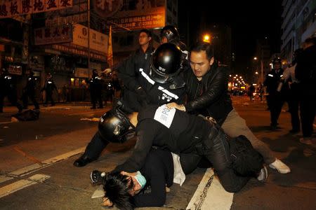 A protester (bottom) is arrested by riot police during a clash at Hong Kong's Mongkok shopping district, China early February 9, 2016. REUTERS/Liau Chung-ren