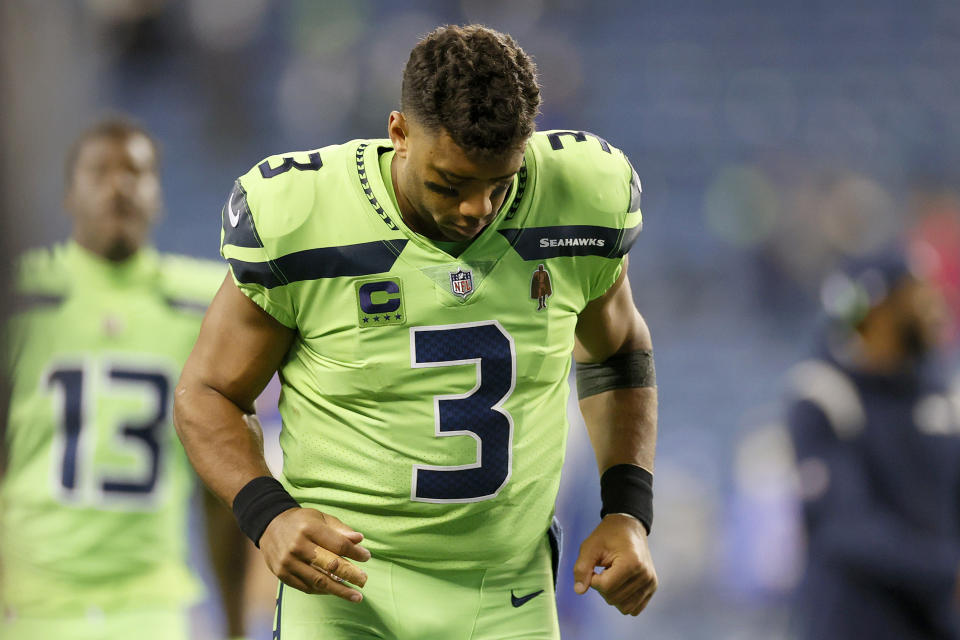 SEATTLE, WASHINGTON - OCTOBER 07:Russell Wilson #3 of the Seattle Seahawks jogs off the field while tending to his finger injury after losing 26-17 to the Los Angeles Rams at Lumen Field on October 07, 2021 in Seattle, Washington. (Photo by Steph Chambers/Getty Images)