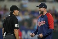 Umpire James Hoye (92) listens to Minnesota Twins manager Rocco Baldelli after Texas Rangers' Mitch Garver was hit by a pitch thrown by Twins starter Sonny Gray in the fifth inning of a baseball game, Friday, July 8, 2022, in Arlington, Texas. (AP Photo/Tony Gutierrez)