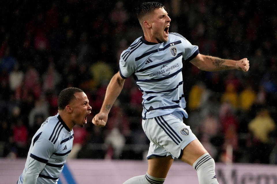 Sporting Kansas City midfielder Rémi Walter, right, and defender Logan Ndenbe celebrate after Walter scored a goal during the first half of an MLS playoff soccer match against St. Louis City Sunday, Oct. 29, 2023, in St. Louis. (AP Photo/Jeff Roberson)
