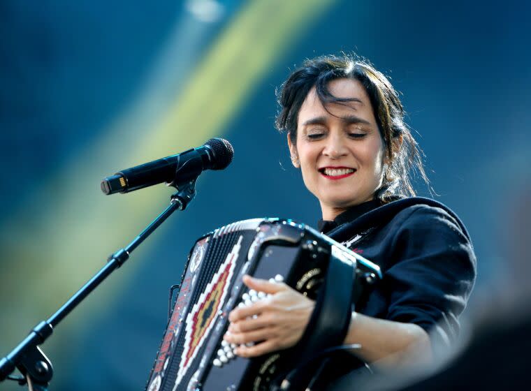 Julieta Venegas plays the accordion at the first Besame Mucho Festival, at Dodger Stadium on Saturday, Dec. 3, 2022. More than 50 bands and singers performed on four stages spread out throughout the Dodger Stadium parking lots.