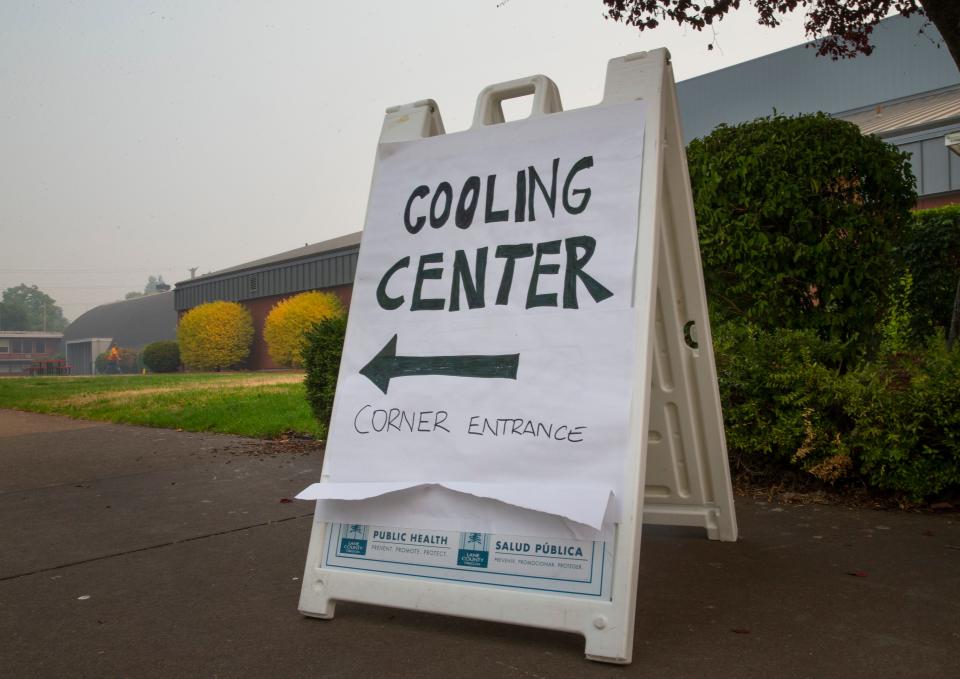 A sign welcomes visitors Tuesday to a Cooling Center at the Lane County Fairgrounds as a head wave descends on the area.