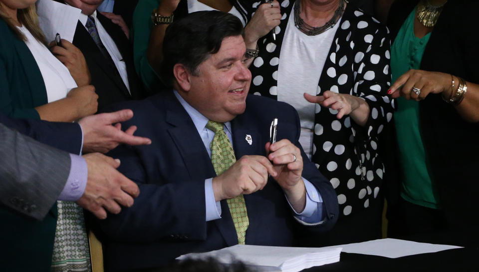 Illinois Gov. J.B. Pritzker signs into law a bill to legalize marijuana in Illinois next year, at the Sankofa Cultural Center in Chicago, on Tuesday, June 25, 2019. (Antonio Perez/Chicago Tribune/TNS via Getty Images)