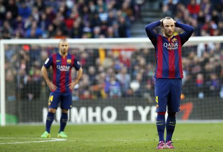 Barcelona's Ivan Rakitic (R) gestures during the Spanish First division soccer match against Malaga at Camp Nou stadium in Barcelona February 21, 2015. REUTERS/Albert Gea