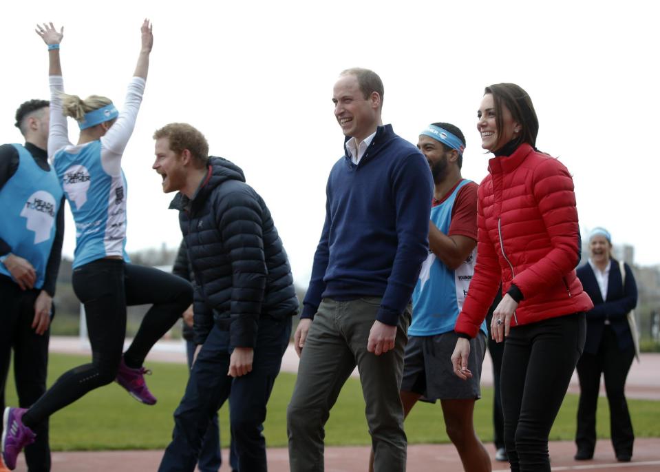 Britain's Prince William, centre, Kate, the Duchess of Cambridge, right, and Prince Harry react as they take part in a relay race, during a training event to promote the charity Heads Together, at the Queen Elizabeth II Park in London, Sunday, Feb. 5, 2017. (AP Photo/Alastair Grant, Pool)