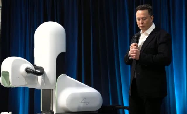 Elon Musk with V2 Neuralink robot